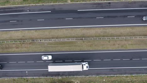 Drone-vertical-fix-shot-above-a-busy-highway.-Cars-and-trucks-France